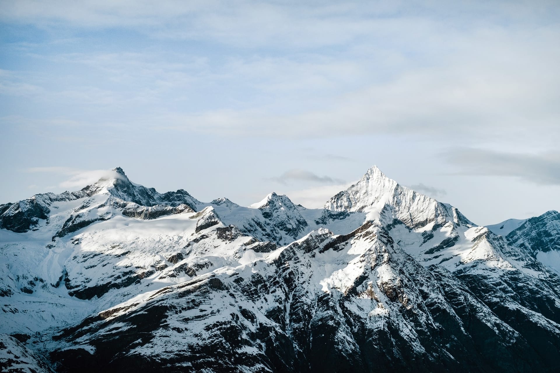 Snow-covered mountains Rocky mountain ridge with snow-covered tops